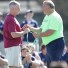 St. Joseph's Univ. coach Pat Cullinan accepts an honorary coach's whistle from Pat Colleluori, father of the late Nick Colleluori