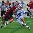 Duke's Jordan Wolf (right, Lower Merion) takes a hit in Sunday's win. Wolf had two goals and an assist. (Photo by Charlie Bagent)
