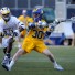 Delaware freshman Connor Frisina (Conestoga) scores one of his two goals in Saturday's 11-10 loss to Drexel as Clifton Simeon defends (Photo by Tim Flatley)