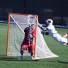 Brown freshm,an Henry Blynn flies through the air for a goal that was called back for a crease violation (For Phillylacrosse.com)