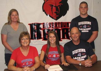 Boyertown senior Kaitlyn DeHaven, flanked by parents Carol and Brian DeHaven, signs a national letter of intent to accept an athletic scholarship to play Division I lacrosse at Duquesne University during a recent ceremony at the high school. Also on hand for the signing were Boyertown coach Pam Wernersbach and brother Jake DeHaven.